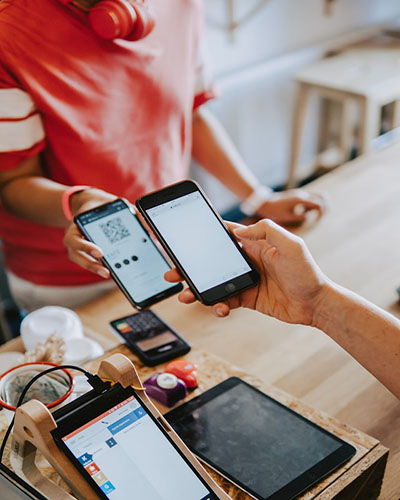 client interacting with an employee while scanning a bar code with his smart phone from a company's representative smart phone at a point of service